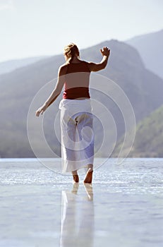 Young woman wading in lake photo