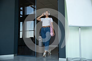 Young woman waiting for departure in airport, traveler with small baggage, influencer`s lifestyle