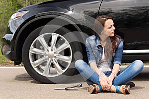 Young woman waiting for roadside assistance