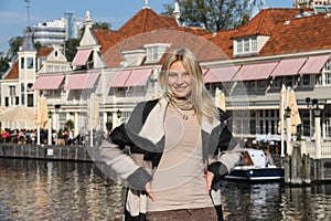 Young woman waiting for tour boat in Amsterdam, the Netherlands