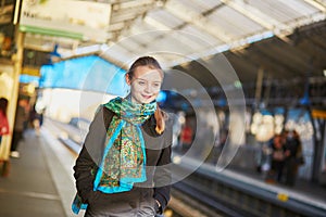 Young woman waiting for a train on the platform of Parisian underground