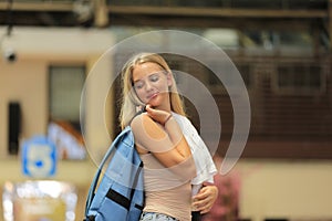 Young woman waiting train, relaxed and carefree at the station platform in Bangkok, Thailand before catching a train.