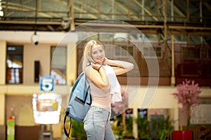 Young woman waiting train, relaxed and carefree at the station platform in Bangkok, Thailand before catching a train.