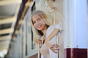 Young woman waiting train, relaxed and carefree at the station platform in Bangkok, Thailand before catching a train.