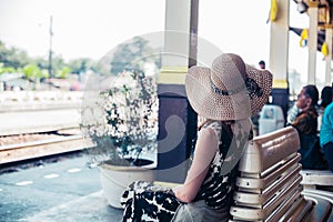 Young woman waiting at train station