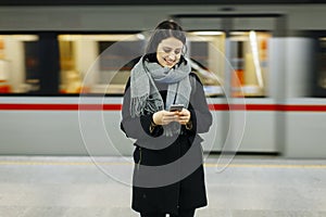 Young woman waiting train in underground