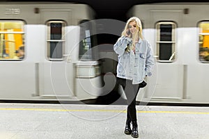 Young woman waiting train in underground