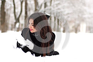 A young woman walk in a winter park