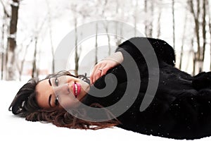 A young woman walk in a winter park