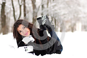 A young woman walk in a winter park