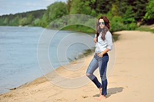 Young woman walkin on a beach