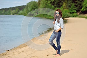 Young woman walkin on a beach photo