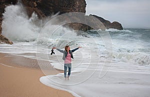 Young woman walking alone on the deserted coast of the Atlantic