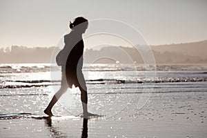 Young woman walking along beach