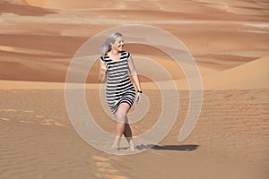 Young woman walking around desert.