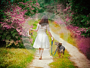 Young woman walking barefoot with dog