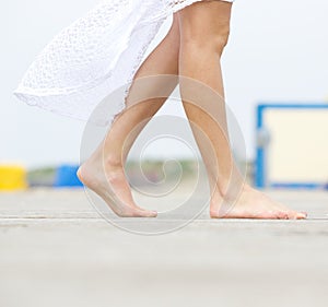 Young woman walking barefoot outdoors