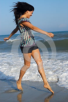 Young woman walking on beach