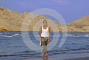 Young Woman Walking at the Beach