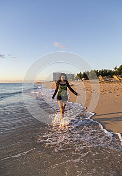 Young Woman Walking on the Beach