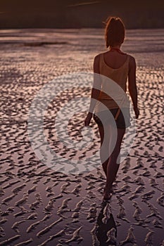 Young woman walking on the beach