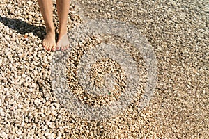 Young woman walking on the beach. Summer vacation concept. Painted toe nails.