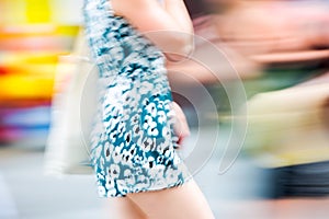 Young woman walking blurred image. Londoners at warm summer day. UK, London