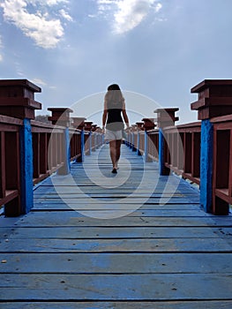 Woman walking on the dock of Labuan Bajo, Komodo, Indonesia photo