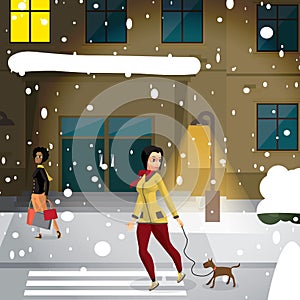 Young woman is walking with a dog outdoors on a winter snowy eve