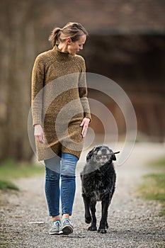 Young woman walking her dog