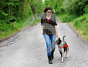 Young Woman Walking her dog for exercise