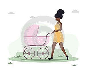 Young woman walking with her newborn child in an pram. Girl on a walk with a stroller and a baby in nature in the open
