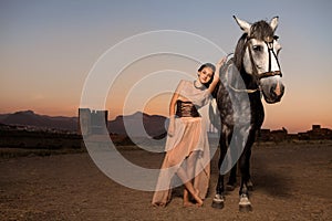 Young woman walking with horse