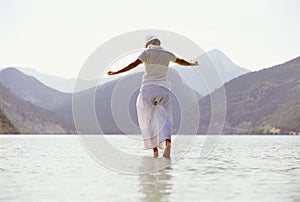 Young woman walking in lake