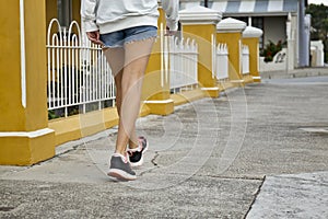 Young woman walking a long a concrete path