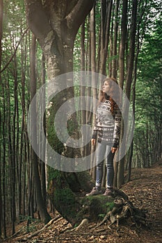 Young woman walking in magic forest