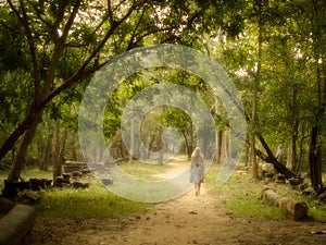 Young Woman Walking on Mysterious Path into Enchanted Forest