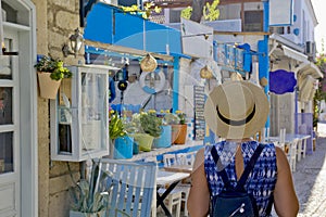 Young woman walking in narrow street in Alacati, Cesme