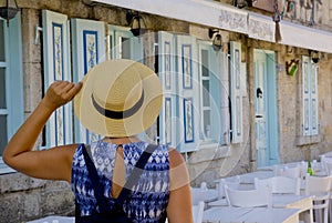 Young woman walking in narrow street in Alacati, Cesme