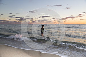 Young Woman Walking in the Ocean