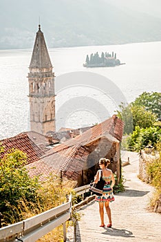 A young woman walking in the old town of Perast, Montenegro