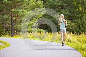 Young woman walking outdoor in the forest