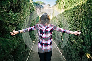 Young woman walking in the park labyrinth