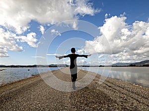 Young woman walking by the sea