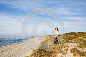 Young woman walking on the seacoast