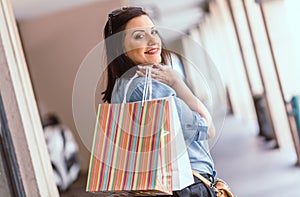 Young woman walking with shopping bags in hand