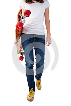 Young woman walking with skateboard