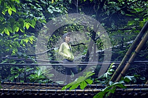 Young woman walking on the suspension bridge