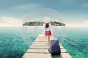 Young woman walking toward island