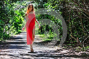 Young Woman Walking on The Tropical Road